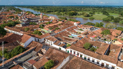 Aerial view of the historic town Santa Cruz de Mompox in sunlight with river and green sourrounding, World Heritage photo