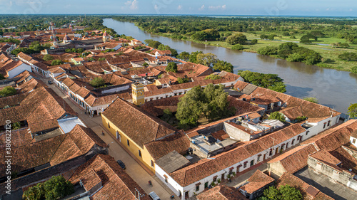 Aerial view of the historic town Santa Cruz de Mompox in sunlight with river and green sourrounding, World Heritage photo