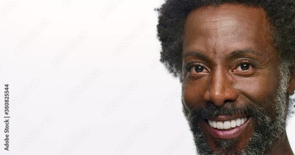 Close up of a man turning towards camera with a huge smile. Close up of a man turning towards camera with a huge smile.