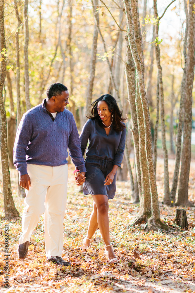 Portrait of a happily married African American couple walking through the park Portrait of a happily married African American couple walking through the park