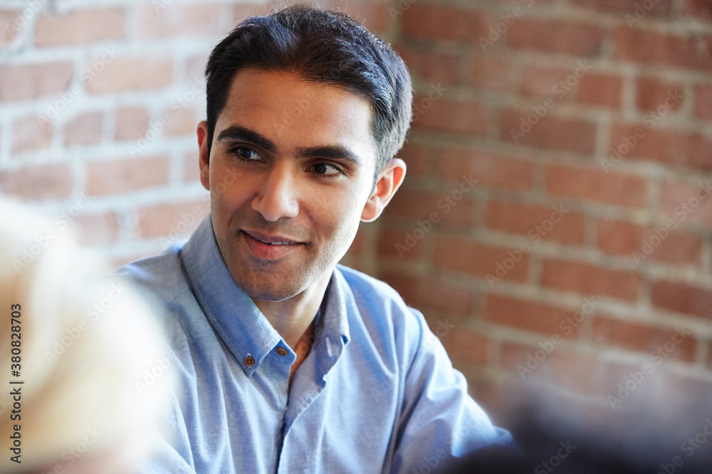 Close-up portrait of millennial Indian businessman in meeting Close-up portrait of millennial Indian businessman in meeting