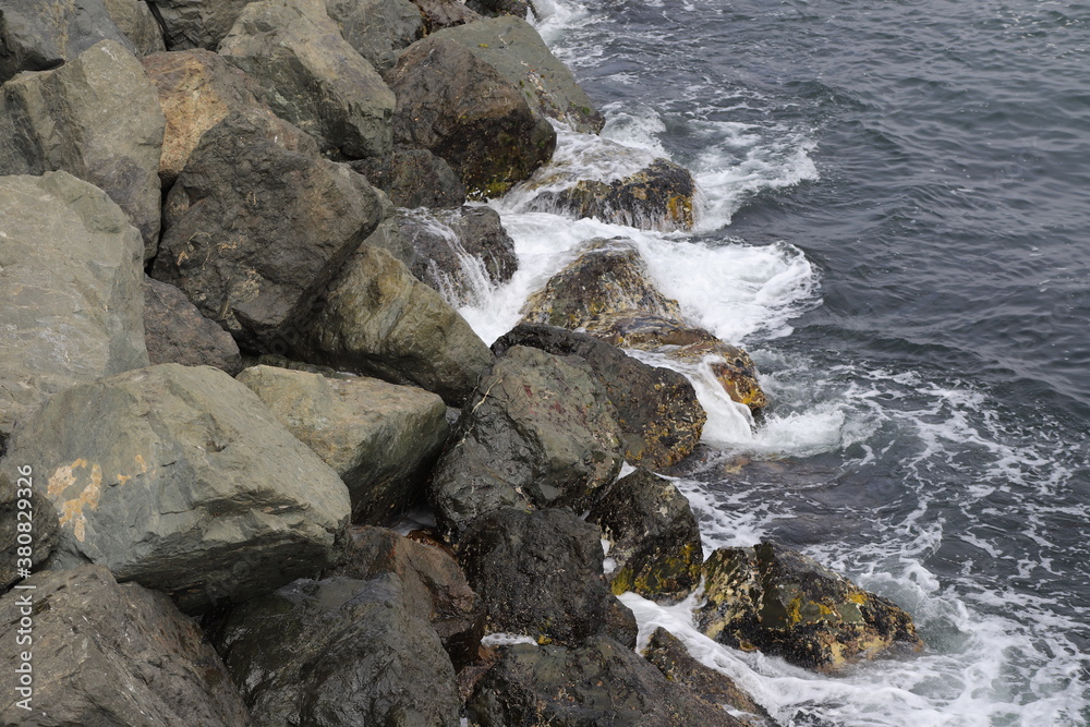 Waves from the Sea Crashing over Rocks on the Coast