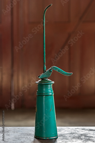 Old-fashioned oil can in a workshop photo