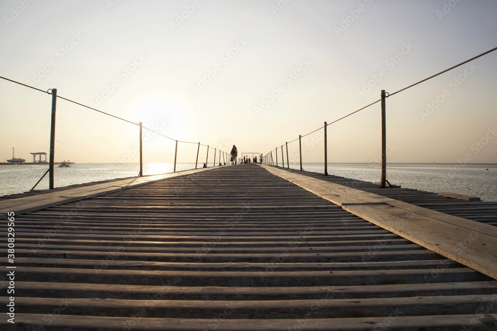 wooden bridge on the beach on the sea.