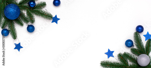 Christmas flatlay with fir branches, blue and silver  decorations on white background. Christmas composition, top view, copy space. New Year background.