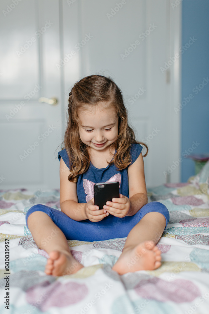 Cute young girl taking picture of herself with a smartphone Cute young girl taking picture of herself with a smartphone