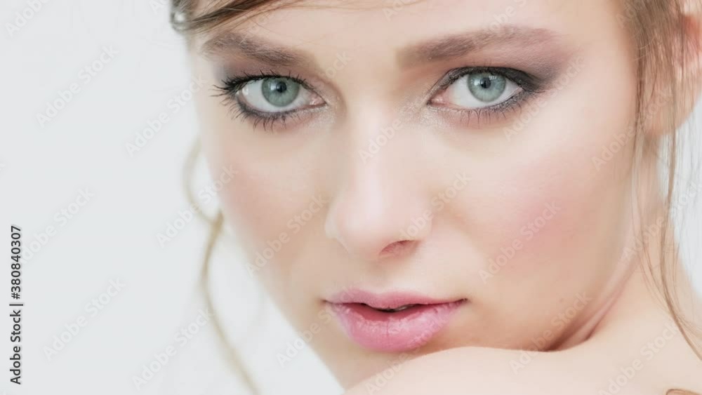 Beautiful healthy woman with fresh skin of face over white background. Young white girl looks to the camera. Woman's face with a blue eyes. Pretty caucasian model is posing before camera. Beautiful healthy woman with fresh skin of face over white background. Young white girl looks to the camera. Woman's face with a blue eyes. Pretty caucasian model is posing before camera.