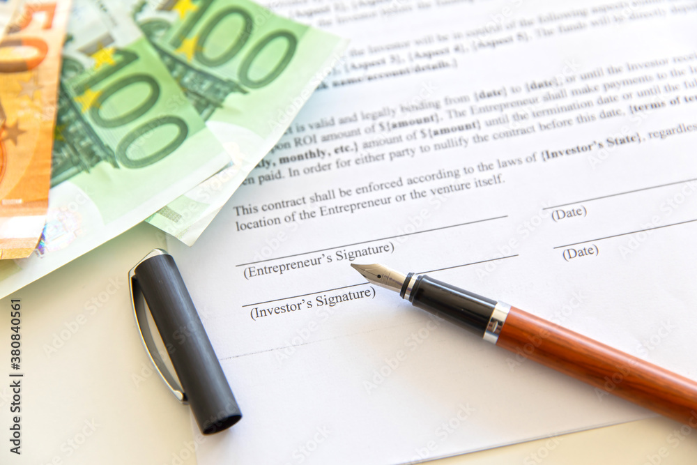 Closeup of contract and money.