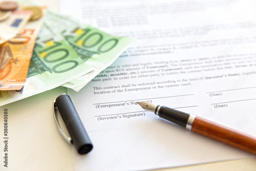 Closeup of contract and money.
