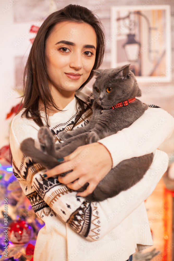 Portrait of happy girl holding her cat on christmas day. Portrait of happy girl holding her cat on christmas day.