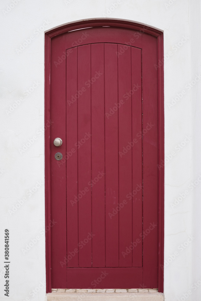 Smart closed wooden door in white wall Smart closed wooden door in white wall