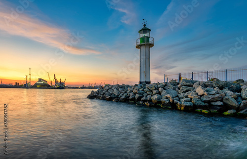 lighthouse on the pier at sunset