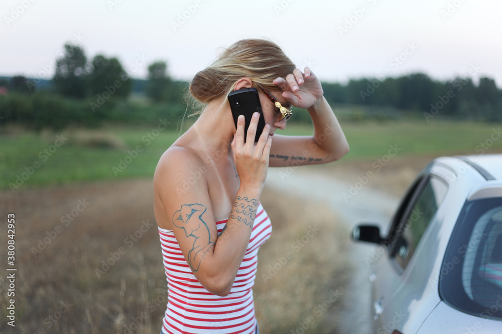 Handsome tattooed woman talking on a phone Handsome tattooed woman talking on a phone