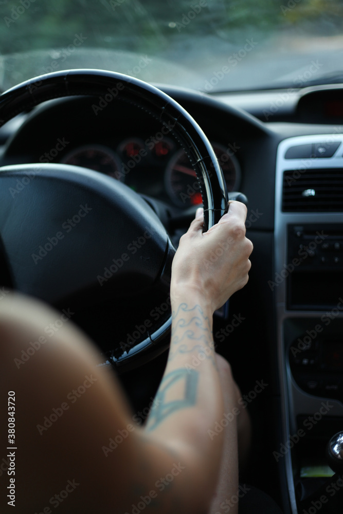 Female hand on a steering weel Female hand on a steering weel