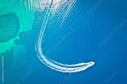 Speed boat and water parachute or parasailing aerial view photo