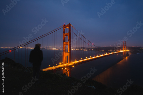 Person viewing the golden gate brige at night photo