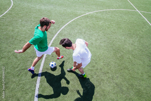 Soccer player dribbling past defender during a soccer game. Overhead