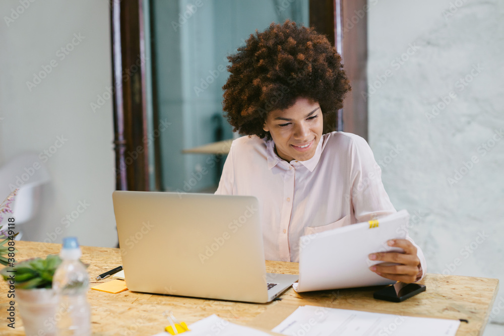 Businesswoman sitting at office reading a documents. Businesswoman sitting at office reading a documents.