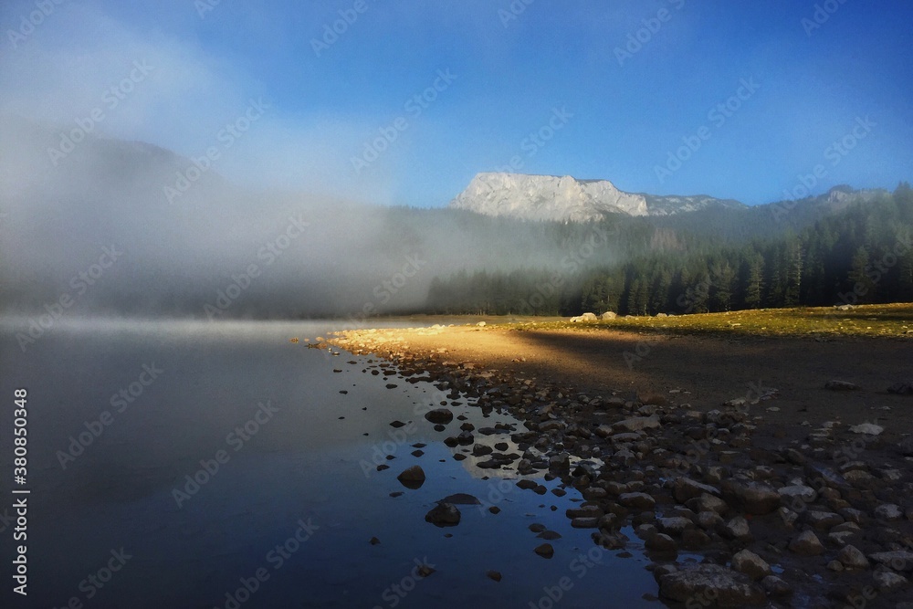Beautiful mountain scenery with peaks above the lake in the early morning Beautiful mountain scenery with peaks above the lake in the early morning