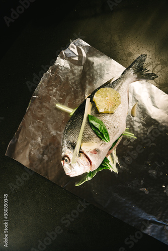 Fresh fish with lemon, garlic and herbs - gilthead seabream