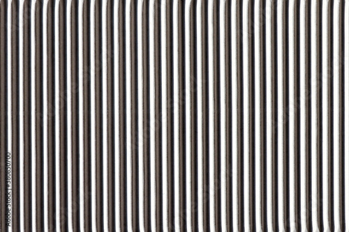Corrugated white paper. Vertical contrast stripes, hard light, dark shadow. Horizontal background for banner, copy space. Abstract surface. Image with rhythm