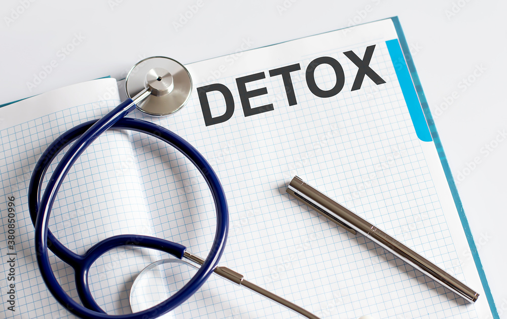 Paper with text DETOX on table with stethoscope Paper with text DETOX on table with stethoscope