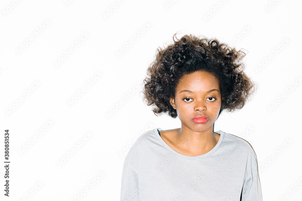 Woman with blank expression in front of wall Woman with blank expression in front of wall