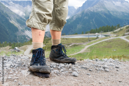 Man wearing old boots with soles ripped off because of so much walking photo