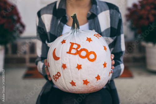 Painted: Girl Holding Fun White Painted Pumpkin photo