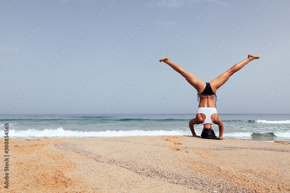 Woman Doing Yoga Exercises at the Beach Woman Doing Yoga Exercises at the Beach