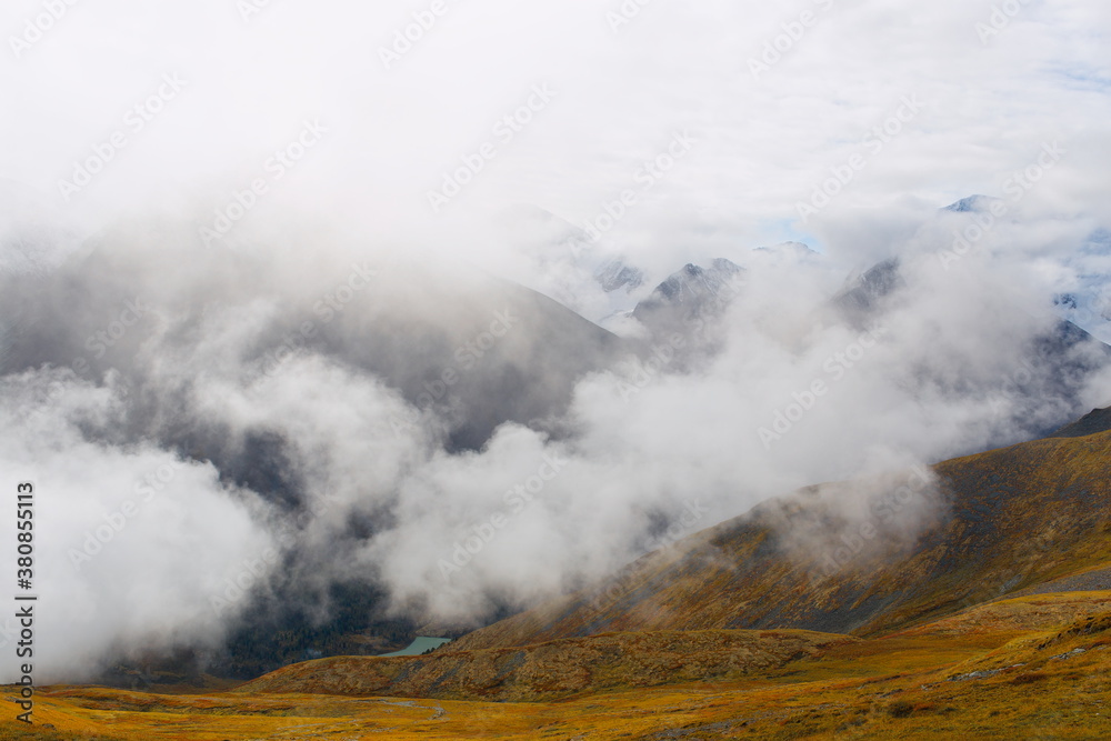 Alpine landscape. Photo of clouds from a high mountain. The birth of clouds in the mountains. Soft focus. Mountain valley, top view. Clouds float between the mountains. Alpine landscape. Photo of clouds from a high mountain. The birth of clouds in the mountains. Soft focus. Mountain valley, top view. Clouds float between the mountains.