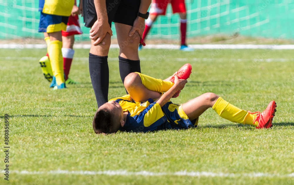 Sufferer child football player on the field. Sufferer child football player on the field.