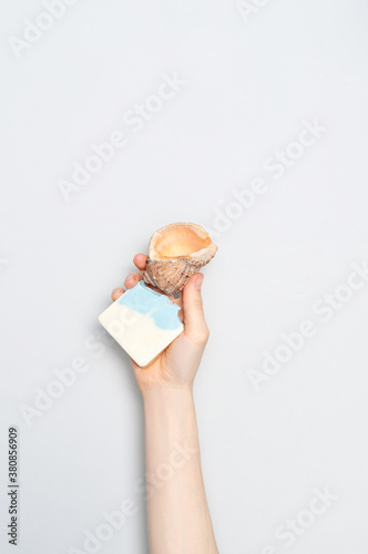 Obraz na płótnie Woman holding natural handmade soap bar on white cloth background w salonie