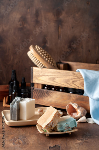 Obraz na płótnie Natural handmade soap bar in ceramic soap dish with spa accessories on wooden table w salonie