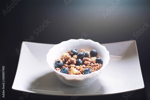 A healthy breakfast cereal with milk and fruit. Oat and corn flakes with chocolate and yogurt. The concept of healthy and vegetarian food.