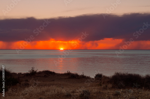 sunset into the ocean at Port Willunga, South Australia photo