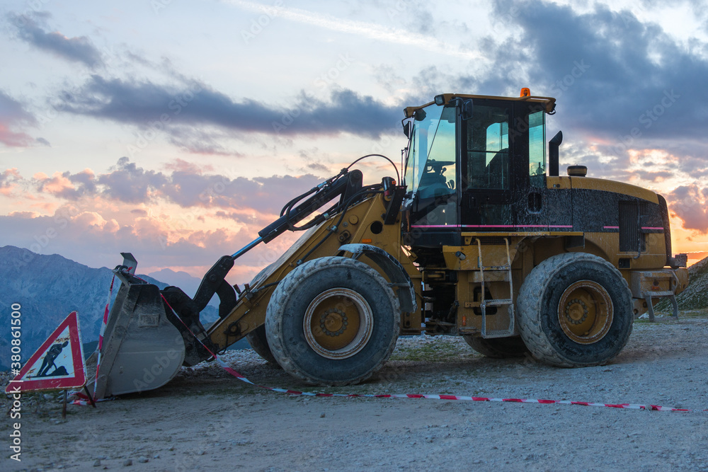 Bulldozer and men at work sign after working day outdoor Bulldozer and men at work sign after working day outdoor