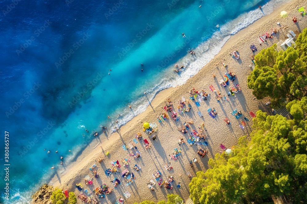 Summer seascape. Aerial view on beach and people. Vacation and relax. Top view from drone at beach and blue sea. Aerial landscape. Travel image