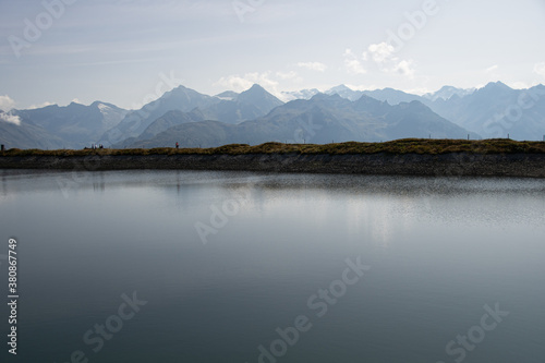 artificial lake with the Austrian Alps in the background