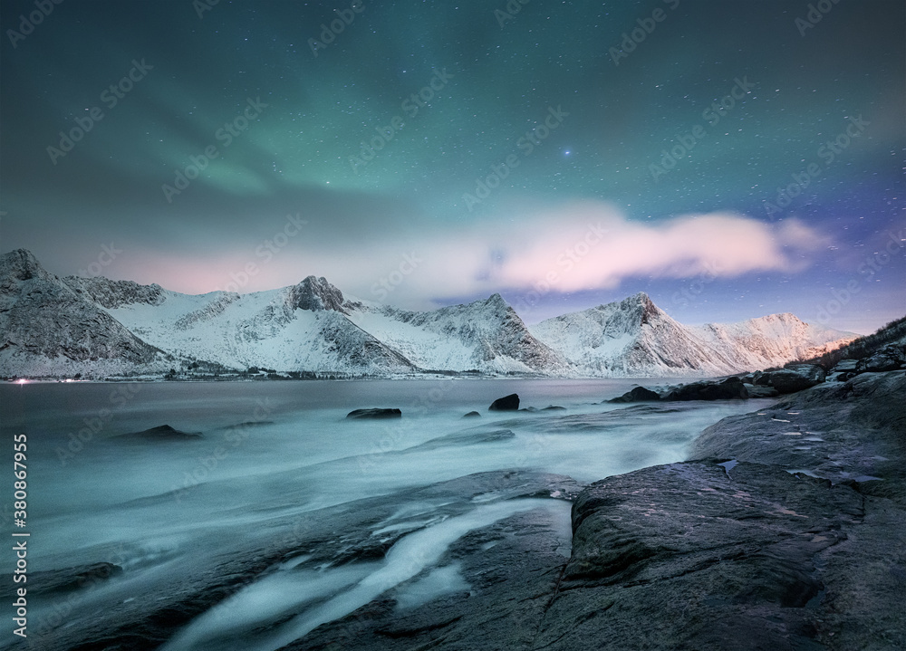 Aurora borealis on Lofoten islands, Norway. Green northern lights above mountains. Night winter landscape with aurora. Natural background in the Norway. Aurora borealis on Lofoten islands, Norway. Green northern lights above mountains. Night winter landscape with aurora. Natural background in the Norway.