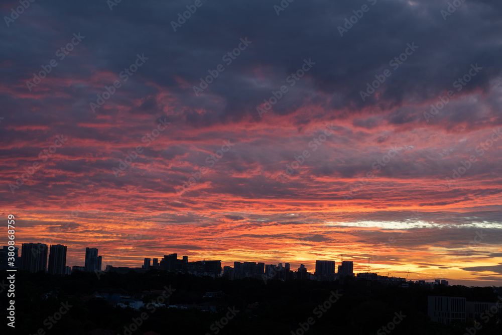 Warm sunset over city skyline with tall buildings in the foreground Warm sunset over city skyline with tall buildings in the foreground