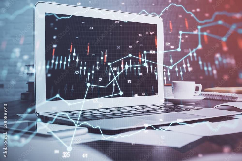 Stock market chart hologram drawn on personal computer background. Multi exposure. Concept of investment. Stock market chart hologram drawn on personal computer background. Multi exposure. Concept of investment.