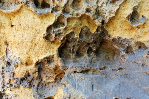 Close-up of holey natural sandstone rocks. Sandstone background