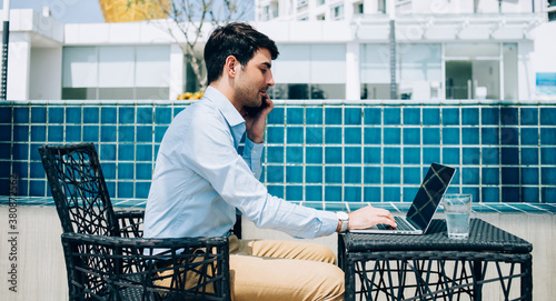 Canvas Print Modern man working with gadgets on sunny terrace