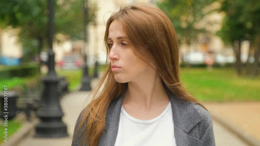 A young, Caucasian charismatic blonde with long hair and braces on her teeth looks to the side and then fixes her gaze at the camera. Calm emotions. Summer evening. A young, Caucasian charismatic blonde with long hair and braces on her teeth looks to the side and then fixes her gaze at the camera. Calm emotions. Summer evening.