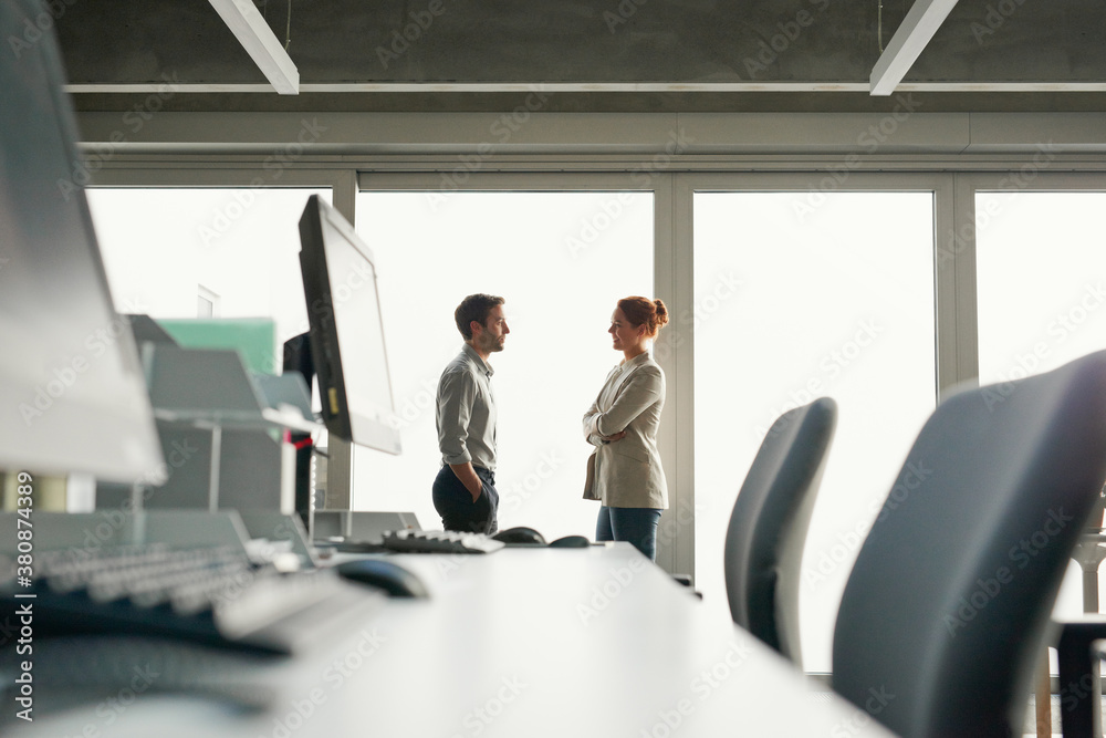 Profile silhouette of business people close to windows Profile silhouette of business people close to windows