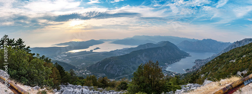 Stunning panorama of Montenegro  city of Kotor  Perast  Tivat and marvelous Kotor bay. View from highest point on mountain road. Beautiful mountains of Montenegro above the sky with clouds at sunset.