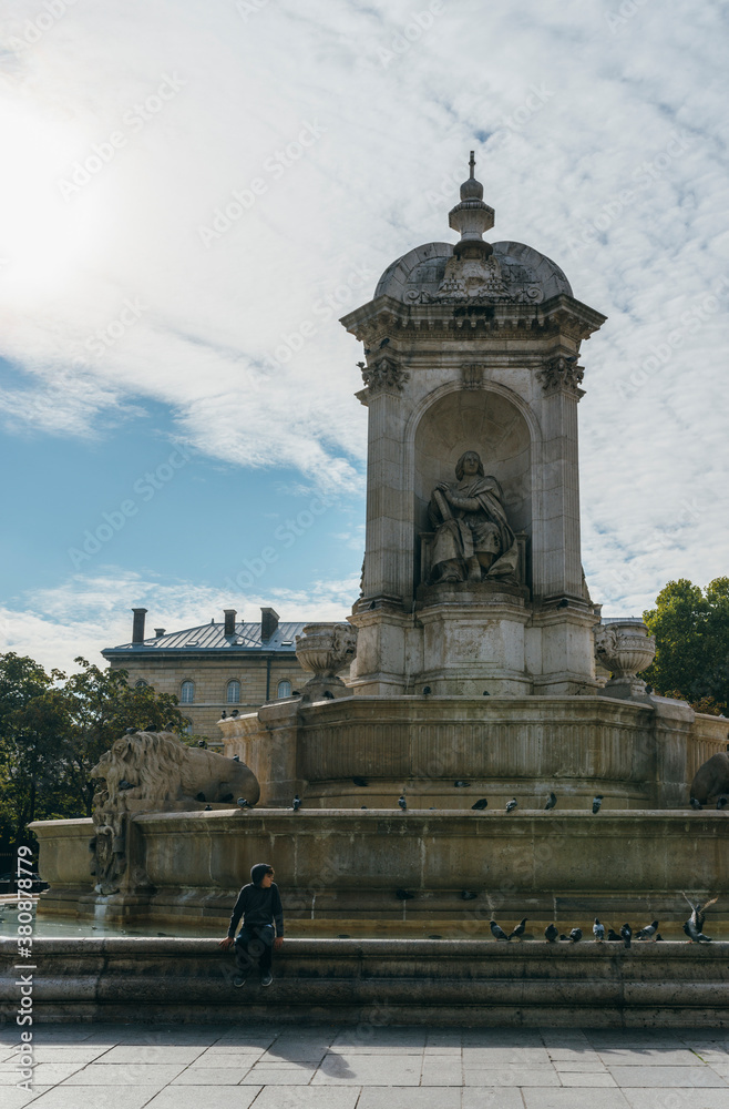 Boy sitting alone on edge of fountain Boy sitting alone on edge of fountain