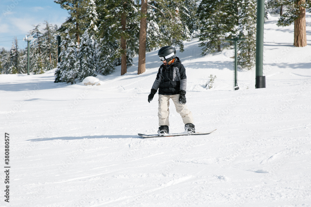 Kid having fun riding his snowboard Kid having fun riding his snowboard