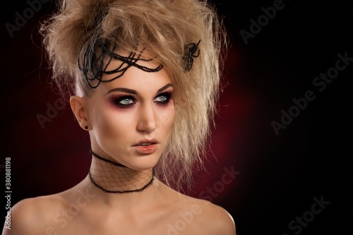 Closeup portrait of decorative young woman in scary halloween makeup.